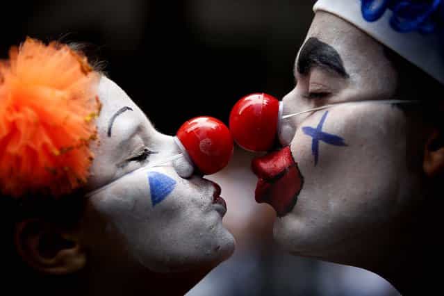 A couple dressed as clowns participate in the [Cordao da Bola Preta] street parade in Rio de Janeiro. (Photo by Felipe Dana/Associated Press)