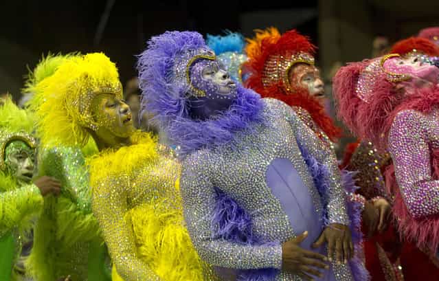 Dancers from the Rosas de Ouro samba school perform during a carnival parade in Sao Paulo, Brazil, early Saturday, February 9, 2013. The Carnival season culminates on Tuesday, February 12, 2013, with street revelry and the pageantry of the Rex and Zulu parades. (Photo by Andre Penner/AP Photo)
