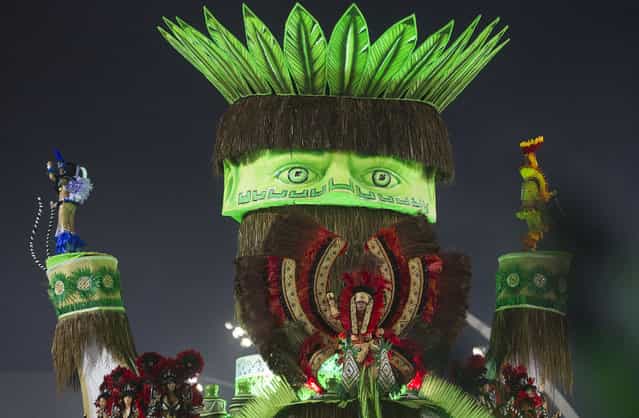 Dancers from the X-9 Paulistana samba school perform on a float during a carnival parade in Sao Paulo, Brazil, early Saturday, February 9, 2013. (Photo by Andre Penner/Associated Press)