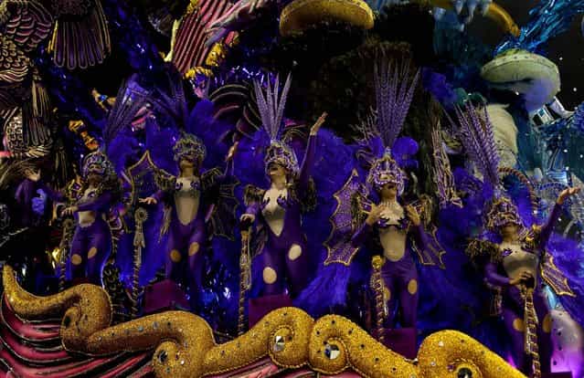Dancers from the Nene da Vila Matilde samba school perform on a float during a carnival parade in Sao Paulo, Brazil, Saturday, February 9, 2013. (Photo by Andre Penner/AP Photo)