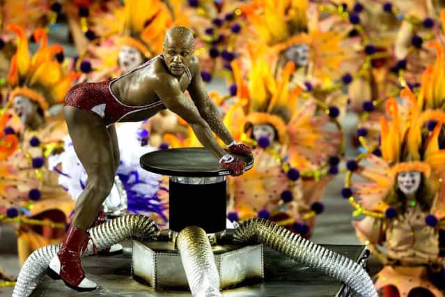 A performer from the Academicos do Salgueiro samba school parades during carnival celebrations at the Sambadrome in Rio. (Photo by Felipe Dana/Associated Press)