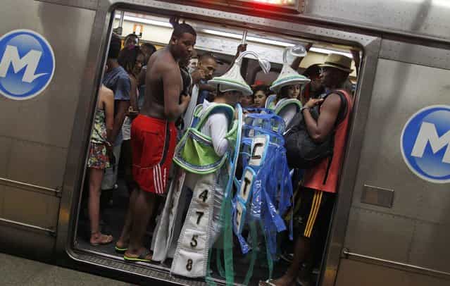 Revellers pack into a subway train as they make their way to the Sambadrome for the first night of the annual Carnival parade in Rio de Janeiro, February 10, 2013. (Photo by Pilar Olivares/Reuters)