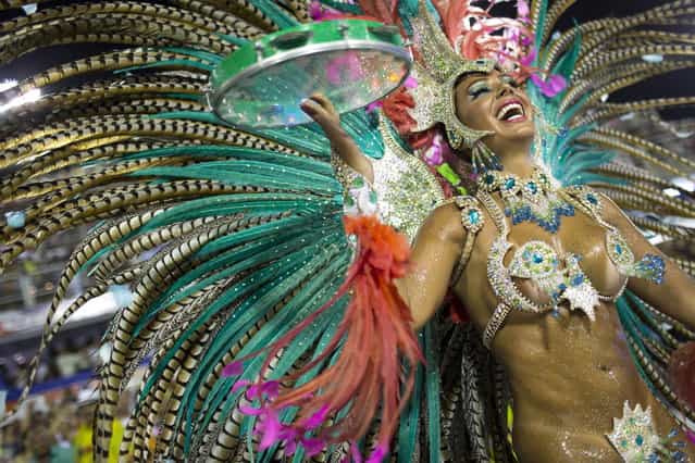Maria Caren Paz, from Argentina, from the Mangueira samba school parades during carnival celebrations at the Sambadrome in Rio de Janeiro, Brazil, Monday, February 11, 2013. (Photo by Felipe Dana/AP Photo)