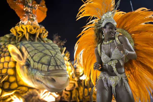 A performer from the Unidos de Vila Isabel samba school parades during Carnival celebrations at the Sambadrome in Rio de Janeiro, Tuesday, February 12, 2013. Rio de Janeiro's samba schools vied for the title of the year's best in an over-the-top, all-night-long Carnival parade at the city's iconic Sambadrome. (Photo by Felipe Dana/AP Photo)
