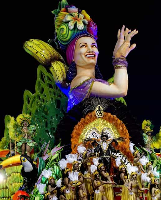 Dancers from the Mancha Verde samba school perform on a float during a Carnival parade in Sao Paulo. (Photo by Andre Penner/Associated Press)