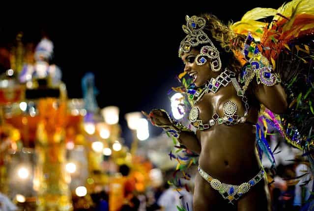 A performer from the Beija Flor samba school participates in the celebrations at the Sambadrome in Rio de Janeiro. (Photo by Felipe Dana/Associated Press)
