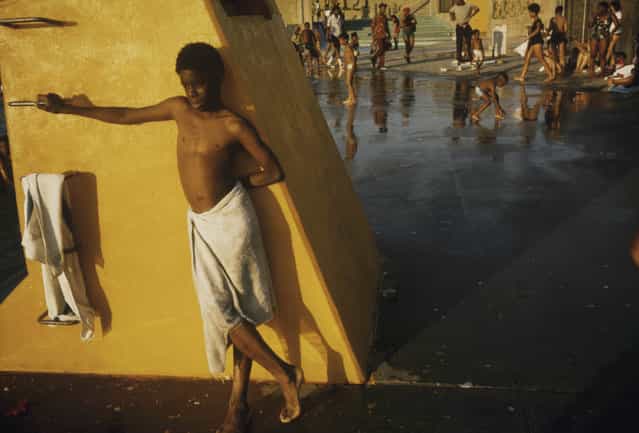 [Boy against a yellow platform at the Kosciusko Swimming Pool in the Bedford-Stuyvesant District of Brooklyn in New York City] New York, New York, July 1974. (Photo by Danny Lyon)