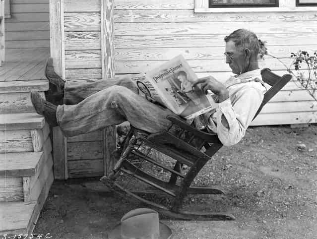 [Farmer reading his farm paper]. Coryell County, Texas, September 1931. (Photo by George W. Ackerman)