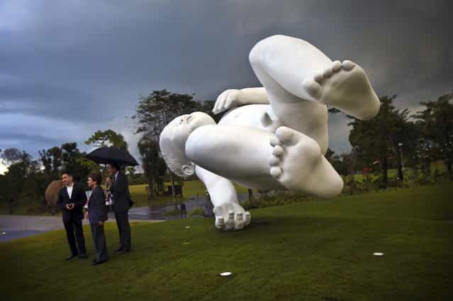 A giant sculpture of a baby titled [Planet] is unveiled at the Gardens By The Bay in Singapore, January 18, 2013. British artist Marc Quinn created the work of art in 2008. (Photo by Wong Maye-E/Associated Press)