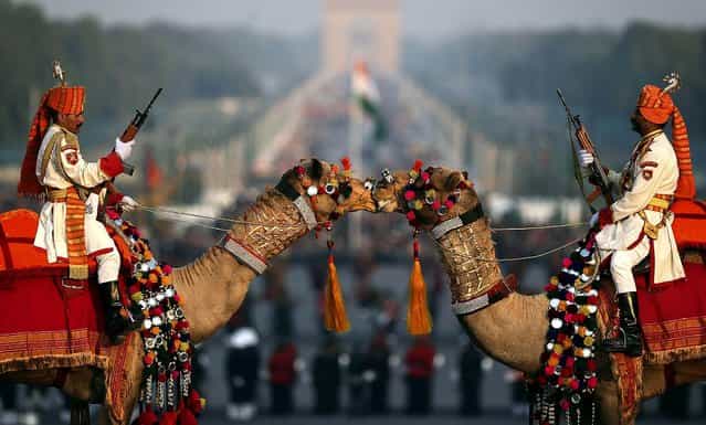 Camel-mounted Indian Border Security Force soldiers in their ceremonial dress participate in full dress rehearsals of the Beating Retreat ceremony at Raisina Hill, which houses India's most important ministries and presidential palace, in New Delh, on January 27, 2013. The ceremony is held annually on January 29, marking the end of Republic Day celebrations. (Photo by Manish Swarup/Associated Press)