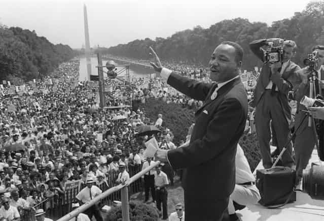 The civil rights leader Martin Luther KIng (C) waves to supporters 28 August 1963 on the Mall in Washington DC (Washington Monument in background) during the [March on Washington]. King said the march was [the greatest demonstration of freedom in the history of the United States]. Martin Luther King was assassinated on 04 April 1968 in Memphis, Tennessee. James Earl Ray confessed to shooting King and was sentenced to 99 years in prison. King's killing sent shock waves through American society at the time, and is still regarded as a landmark event in recent US history. (Photo by AFP Photo)