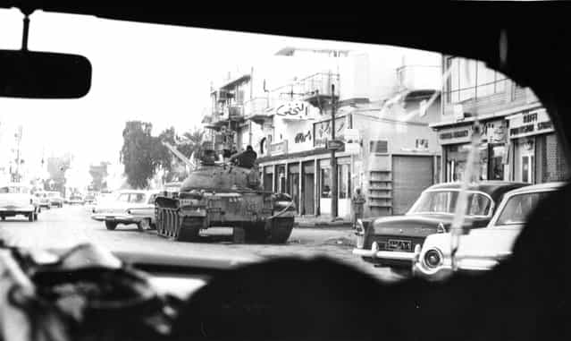 A motorist's view of a street in Baghdad, Iraq, on February 12, 1963, where tanks stand by to prevent further outbreaks of fighting which followed a military coup and overthrow of Premier Abdel Karim Kassem's five-year-old regime by elements of the Ba'ath Party. (Photo by Jim Pringle/AP Photo)