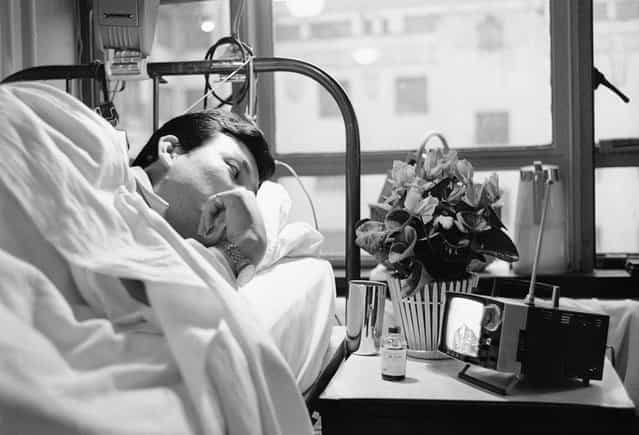The use of small, portable TV sets in the U.S. had not quite caught on in 1963, but in Japan, where they were first developed, viewers were hooked on the miniaturized video machine. Owners of the sets, such as this patient in a Tokyo hospital, took them with them wherever they went. (Photo by Hideyuki Mihashi/AP Photo)