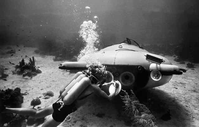 French explorer and oceanographer Jacques-Yves Cousteau near his [diving saucer] during an undersea exploration in the Red Sea, in June of 1963. Together with Jean Mollard, he created the SP-350, a two-man submarine that could reach a depth of 350 m below the ocean's surface. (Photo by OFF/AFP Photo)