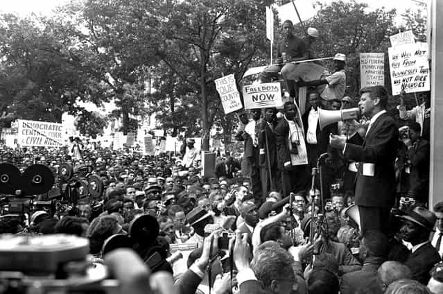 Attorney General Robert Kennedy uses a bullhorn to address black demonstrators at the Justice Department, on June 14, 1963. The demonstrators marched to the White House, then to the District Building, and wound up at the Justice Department. (Photo by AP Photo/STF)