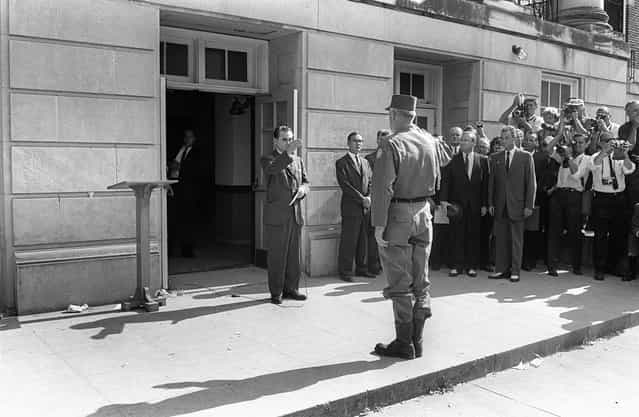 Alabama's governor George Wallace (left) faces General Henry Graham, in Tuscaloosa, at the University of Alabama, on June 12, 1963. Wallace blocked the enrollment of two African-American students, Vivian Malone and James Hood. Despite an order of the federal court, Governor George Wallace appointed himself the temporary University registrar and stood in the doorway of the administration building to prevent the students from registering. In response, President Kennedy federalized the Alabama National Guard. One hundred guardsman escorted the students to campus and their commander, General Henry Graham, ordered George Wallace to [step aside]. Thus were the students registered. Kennedy addressed the public in a June 11 speech that cleared his position on civil rights. The bill that he submitted to Congress was ultimately passed as the Civil Rights Act of 1964. (Photo by OFF/AFP Photo)