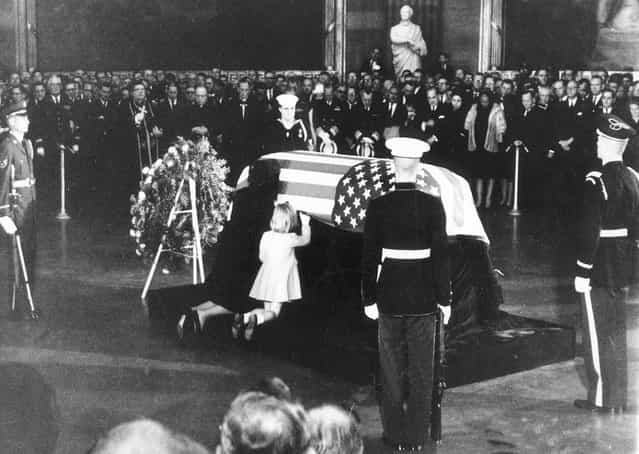 Jackie Kennedy kisses the casket of her late husband, President John F. Kennedy while her daughter Caroline touches it in rotunda of U.S. Capitol, on November 24, 1963. (Photo by AP Photo)