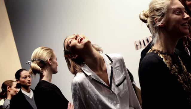 Karlie Kloss laughs during rehearsal backstage at the Ralph Lauren presentation at St. John Center Studios on the last day of Mercedes-Benz Fashion Week in New York on February 14, 2013. (Photo by Erin Baiano/The New York Times)
