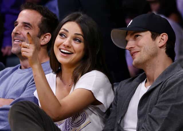 Mila Kunis and actor Ashton Kutcher sit courtside at the Lakers – Suns game at the Staples Center in Los Angeles, February 12, 2013. (Photo by Danny Moloshok/Associated Press)