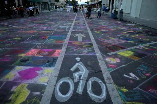 A section of downtown Lake Worth street was dedicated to children so they could practice their street painting technique on Saturday. Chalk was available at no charge at the festival. (Photo by Thomas Cordy/The Palm Beach Post)
