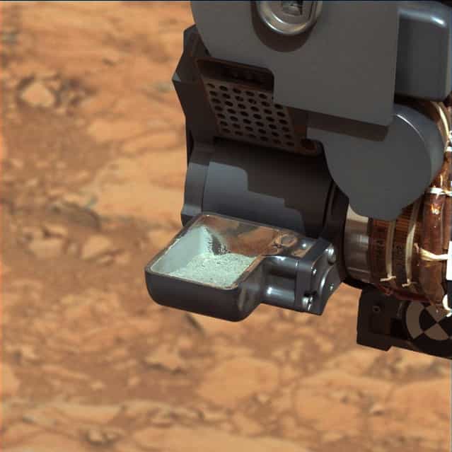 The first sample of powdered rock from Mars extracted by the NASA's Curiosity rover drill is pictured in this February 20, 2013 NASA handout photo. The image was taken after the sample was transferred from the drill to the rover's scoop. The scoop is 1.8 inches (4.5 centimeters) wide. The image has been white-balanced by NASA to show what the sample would look like if it were on Earth. (Photo by NASA/Reuters/JPL-Caltech/MSSS/Handout)