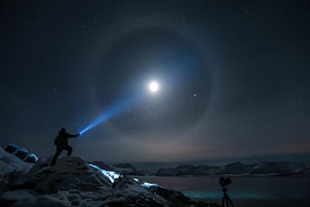 A halo appears around the moon in Kvæfjord, Troms, Norway, on February 19, 2013. Such halos occur when moonlight is refracted by ice crystals in the atmosphere. (Photo by Steve Nilsen/Andre Sørensen)