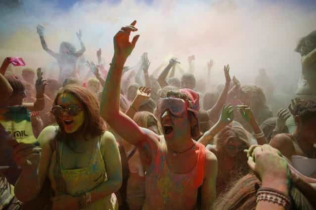 Revellers are covered in coloured cornflour powder as they take part in the Holi One festival in Cape Town, March 2, 2013. The event is inspired by the Hindu Holi spring festival of colour which originated in India. (Photo by Mark Wessels/Reuters)