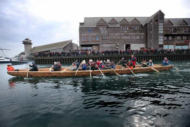 Crew in Britain's first ever full-size reconstructed sea-going Bronze Age boat, paddle out to sea near to the National Maritime Museum as it makes its maiden voyage on March 6, 2013 in Falmouth, England. With a crew of of 18, equipped with Bronze-Age-style wooden paddles, the 15 metre long experimental vessel – a replica of the sort of craft used for long-distance trade between Britain and the continent 4000 years ago – will be used to test prehistoric seafaring methods in a project in collaboration with the University of Exeter and the Falmouth-based National Maritime Museum Cornwall. (Photo by Matt Cardy)