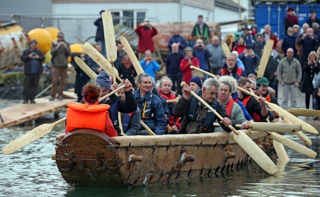 Crew in Britain's first ever full-size reconstructed sea-going Bronze Age boat, paddle out to sea near to the National Maritime Museum as it makes its maiden voyage on March 6, 2013 in Falmouth, England. With a crew of of 18, equipped with Bronze-Age-style wooden paddles, the 15 metre long experimental vessel – a replica of the sort of craft used for long-distance trade between Britain and the continent 4000 years ago – will be used to test prehistoric seafaring methods in a project in collaboration with the University of Exeter and the Falmouth-based National Maritime Museum Cornwall. (Photo by Matt Cardy)