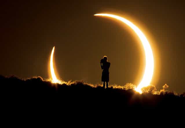 [An Onlooker Witnesses the Annular Solar Eclipse as the Sun Sets on May 20, 2012]. Photo by Colleen Pinski (Peyton, CO). Photographed in Albuquerque, NM, May 2012.