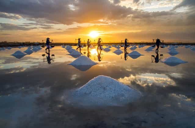 [People Harvesting Salt at Sunset]. Photo by Hoang Giang Hai (Hanoi, Vietnam). Photographed in the Ninh Hoa District, Khanh Hoa Province, Vietnam, August 2012.