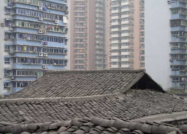 Traditional [dragon scale] tiled rooftops can still be found in Chongqing, the most industrialized city in western China. (Photo by Tom Carter/The Atlantic)