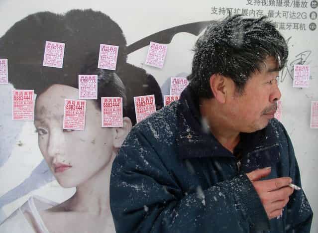 Billboard defaced with stickers advertising jobs in wintery Liaoning. (Photo by Tom Carter/The Atlantic)