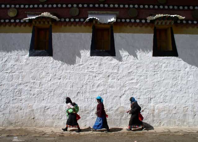 Tibetans walking a kora (spiritual circuit) around a Buddhist temple in southern Gansu. (Photo by Tom Carter/The Atlantic)