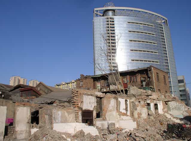 Tianjin's crumbling past juxtaposed against its shiny present. (Photo by Tom Carter/The Atlantic)