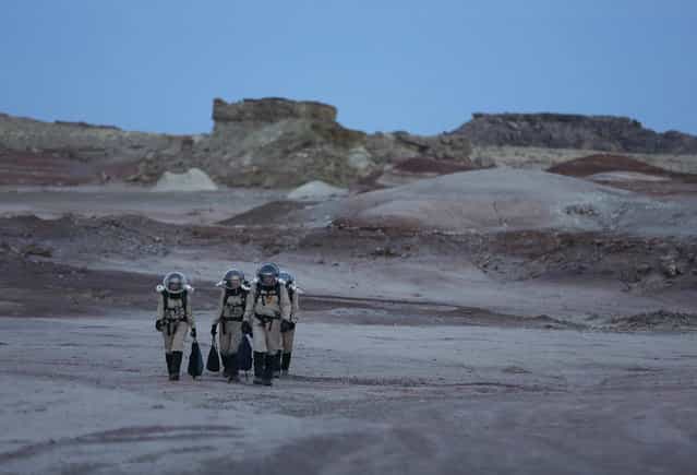 Members of Crew 125 EuroMoonMars B mission return after collecting geologic samples for study at the Mars Desert Research Station (MDRS) in the Utah desert March 2, 2013. The MDRS aims to investigate the feasibility of a human exploration of Mars and uses the Utah desert's Mars-like terrain to simulate working conditions on the red planet. Scientists, students and enthusiasts work together developing field tactics and studying the terrain. All outdoor exploration is done wearing simulated spacesuits and carrying air supply packs and crews live together in a small communication base with limited amounts of electricity, food, oxygen and water. Everything needed to survive must be produced, fixed and replaced on site. (Photo by Jim Urquhart/Reuters)