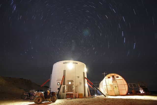A view of the night sky above the Mars Desert Research Station (MDRS) is seen outside Hanksville in the Utah desert March 2, 2013. The MDRS aims to investigate the possibility of a human exploration of Mars and takes advantage of the Utah desert's Mars-like terrain to simulate working conditions on the red planet. Scientists, students and enthusiasts work together to develop field tactics and study the terrain while wearing simulated spacesuits and carrying air supply packs. They live together in a small communication base with limited space and supplies. (Photo by Jim Urquhart/Reuters)