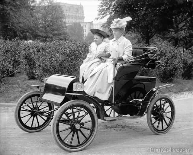Two Women driving (posing) in a car around 1910. Photographed by Harris & Ewing.