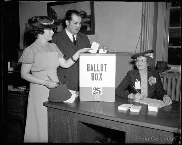 [Washington Votes; first time since 1874. Washington, D.C., April 30. It was a long time between votes, 1874 to 1938, but the Capitol bridged a gap today when its residents cast a city-wide ballot on the question of whether suffrage shall be voted to the voteless community. Mr and Mrs Paul R. Henry are shown depositing their ballots while Miss Magdalena Gale registers them, 4/30/38]. Photographed by Harris & Ewing.