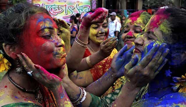 Students smear each other's faces with colored powder as they celebrate Holi at the Rabindra Bharati University campus in Kolkata, India on Friday, on March 22, 2013. (Photo by Bikas Das/Associated Press)
