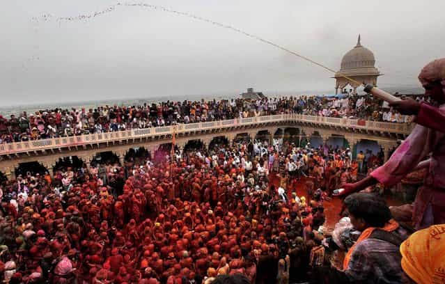 Devotees are smeared with colors and sing at the Nandagram temple, on March 22, 2013. (Photo by Manish Swarup/Associated Press)