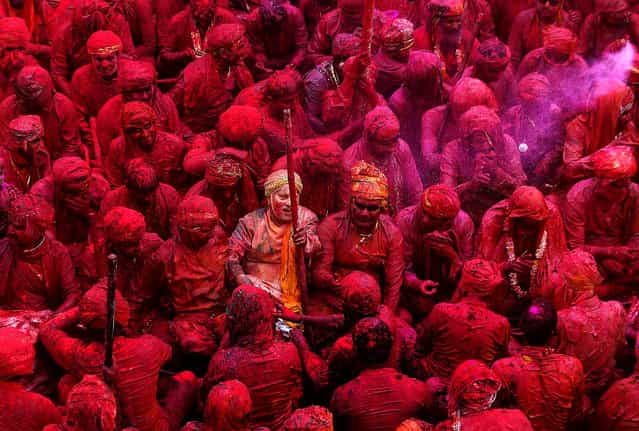 Devotees smeared with colors sing at the Nandagram temple, on March 22, 2013. (Photo by Manish Swarup/Associated Press)
