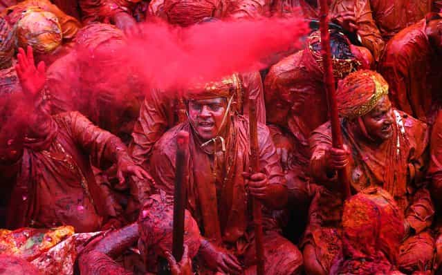 Devotees smeared with colors sing at the Nandagram temple, on March 22, 2013. (Photo by Manish Swarup/Associated Press)