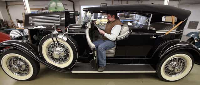 Wayne Reeves checks the paperwork of a 1929 Stutz SV16 Dual Cowl Phaeton Tuesday, March 5, 2013 at L'Cars Automotive Specialties in Cameron, Wis. The company which does high-end restoration and customization work classic cars that have won awards at the world-renowned Pebble Beach Concours d'Elegance. Winning cars include a 57c Bugatti, Rolls Royce PIII V12, V12 Aero coupe, T44 Bugatti, T55 Bugatti, T38A Bugatti, Mercedes Benz 290 Roadster, Rolls Royce Silver Ghost, T57 Bugatti, 1929 Duesenberg J, Mercedes Benz 540K cabriolet, Talbot Teardrop and a 1931 V16 Cadillac convertible. (Photo by Mark Hoffman)