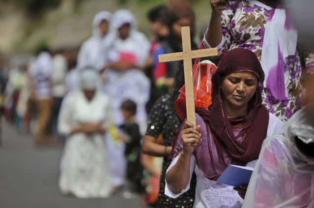 Indian Christian devotees pray on Good Friday in Jammu, India, Friday, March 29, 2013. Christians all over the world are marking Good Friday, the day when Jesus Christ was crucified. (Photo by Channi Anand/AP Photo)