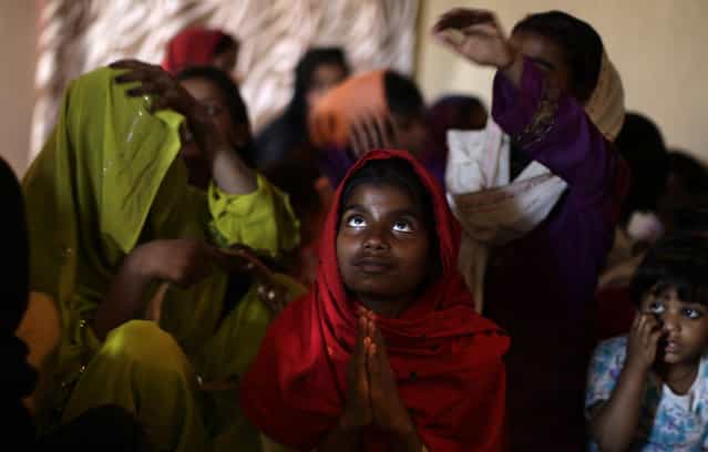 Pakistani Christians pray during a Mass on Good Friday in a church in Islamabad, Pakistan, Friday, March 29, 2013. Christians around the world are marking the Easter holy week. (Photo by Muhammed Muheisen/AP Photo)