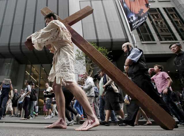 David Carnell plays a part of Jesus Christ during a [Journey to the Cross] procession while celebrating Good Friday in Sydney, Australia, Friday, March 29, 2013. The annual event by Wesley Mission tells the Easter story in a modern Australia. (Photo by Rick Rycroft/AP Photo)