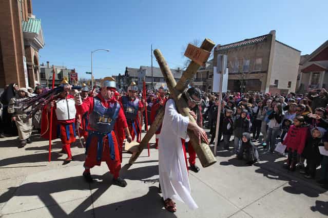 Jose Hernandez portrays Jesus as Catholic faithful gather at St. Vincent de Paul Parish, the first stop on the 29th annual [Crucis Viviente], on Good Friday, March 29, 2013. Coordinated by the Archdiocese of Milwaukee's Hispanic Ministry Office, performers from the Hispanic community will reenact the Stations of the Cross in Spanish. The play recounts major events that occurred before Jesus Christ was sentenced to death by Pontius Pilate. Afterwards, actors, along with the Hispanic Catholic community of southeastern Wisconsin, will follow a mile-and-a-half street route as they pray the Stations of the Cross. Stopping at 15 designated areas, each [station] is marked by posters outlining how Jesus walked to his death and was resurrected (due to the large crowd expected, all streets during the route are closed to traffic). The procession begins at 1 p.m. at St. Vincent de Paul Parish, 2114 W. Mitchell St., Milwaukee. Archbishop Listecki will read Scripture at the ninth station at approximately 3 p.m., at St. Hyacinth Parish, 1414 W. Becher St., Milwaukee. The event concludes at the Basilica of St. Josaphat, 601 W. Lincoln Ave., Milwaukee at approximately 5 p.m. (Photo by Rick Wood)