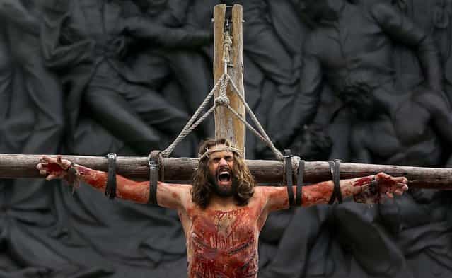 Actor James Burke-Dunsmore portrays the part of Jesus Christ during a performance in London's Trafalgar Square on Good Friday, on March 29, 2013. The play called 'The Passion of Jesus' was a free performance depicting the betrayal, capture, trial, crucifixion and resurrection of Jesus, performed by the Wintershall players. (Photo by Kirsty Wigglesworth/Associated Press)