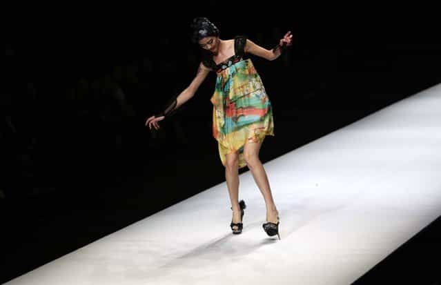 A model nearly falls as she presents a creation by Chinese designer Qi Gang during a fashion show at China Fashion Week for Spring/Summer 2012 in Beijing October 27, 2011. (Photo by Jason Lee/Reuters)